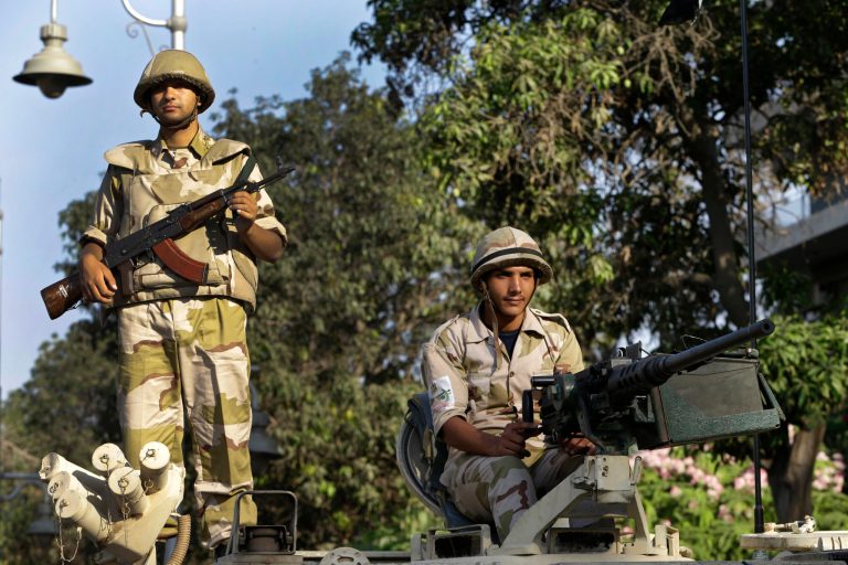Egyptian army soldiers stand guard on their armored personnel carrier, near the presidential palace in Cairo, Egypt, Thursday, July 11, 2013. Egypt's Muslim Brotherhood vowed Thursday not to back down in its push to restore ousted Islamist leader Mohammed Morsi to power but insisted its resistance is peaceful in an effort to distance itself from more than a week of clashes with security forces. (AP Photo/Hussein Malla)