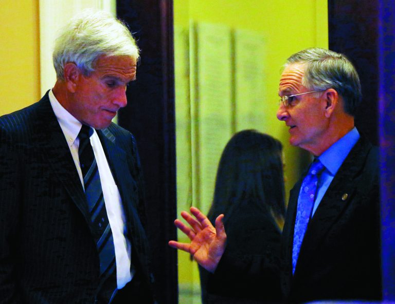 Senate Minority Leader Richard L. Saslaw, D-Fairfax, left, and Senate Majority Leader Thomas K. Norment, Jr., R-James City, right, confer in the rear of the Virginia Senate chamber at the State Capitol in Richmond, Va. Friday, Jan. 25, 2013. The Republican and Democratic members have been at odds all week, since Republicans passed a new redistricting plan while Democratic Senator Henry L. Marsh, III, D-Richmond was attending the Presidential Inauguration. (AP Photo/Richmond Times-Dispatch, Bob Brown).