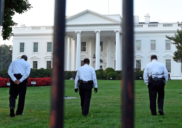 Uniformed Secret Service officers walk along the lawn on the North side of the White House in Washington, Saturday, Sept. 20, 2014. The Secret Service is coming under renewed scrutiny after a man scaled the White House fence and made it all the way through the front door before he was apprehended.  (AP Photo/Susan Walsh)
