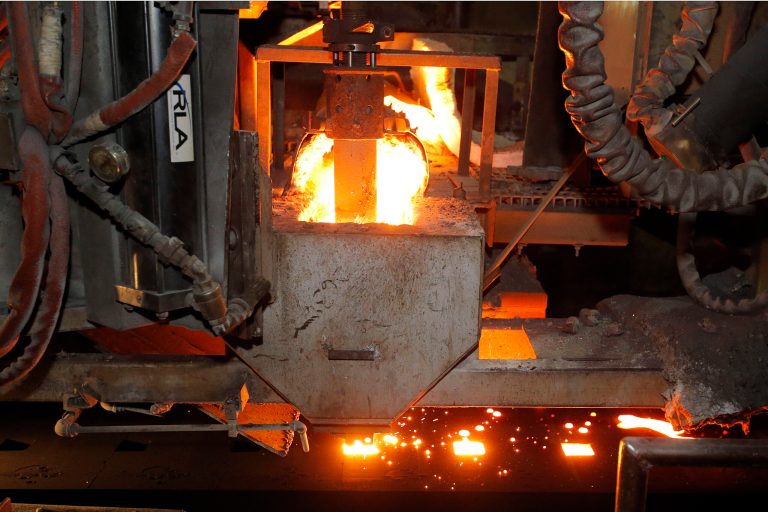 In this May 12, 2014 photo, molten metal is cast at Rochester Metal Products Corp. in Rochester, Ind. The hulking induction furnaces the plant uses to melt scrap iron consume enough electricity to power 7,000 households. (AP Photo/AJ Mast)