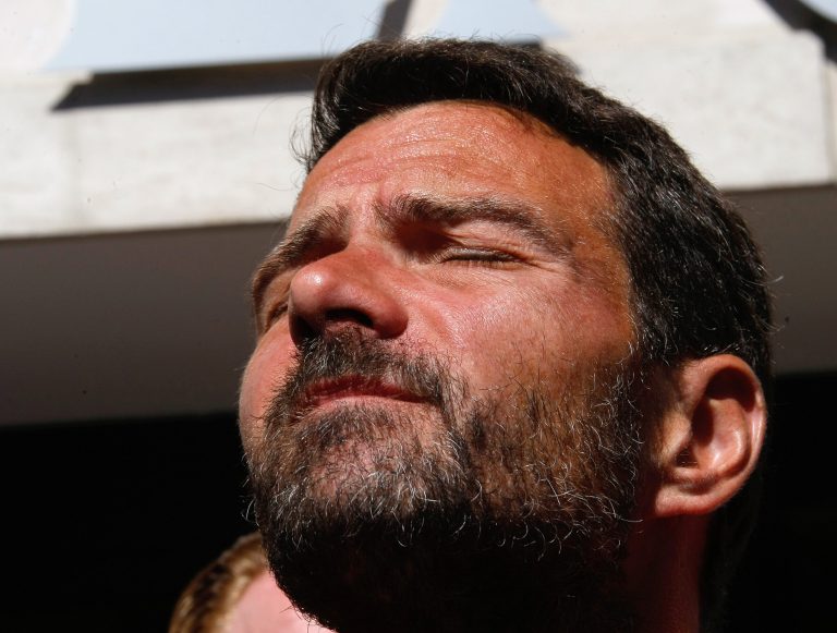 Former trader Jerome Kerviel, closes his eyes during at a press conference in front of his hotel, in Ventimiglia, Italy, near the French border, Sunday, May 18, 2014. The rogue trader facing three years in prison for one of the biggest trading frauds in history is appealing to the French president for mercy. Jerome Kerviel, who almost took down his bank, Societe Generale, with 4.9 billion euros in losses, has been on a months-long pilgrimage back to France after meeting the pope. He stopped his return just short of the border Saturday. Kerviel, convicted in 2010, insists he was the victim of a system that allowed his illegal trades as long as they made money. An appeals court threw out a fine equal to his losses, but upheld his prison sentence. Kerviel is supposed to report to start his sentence by Sunday or be considered a fugitive. (AP Photo/Claude Paris)
