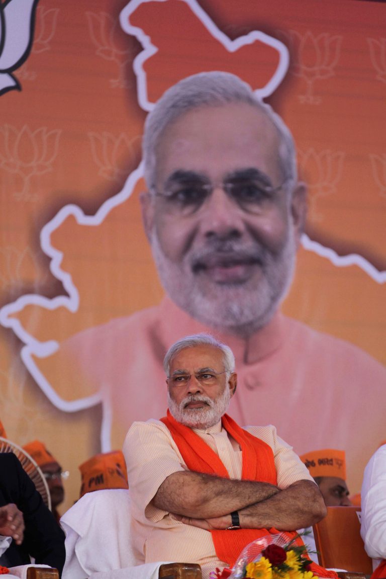 Gujarat state chief minister and Bharatiya Janata Party's prime ministerial candidate Narendra Modi sits during party workers' convention after inaugurating the party's new state headquarters building in Gandhinagar, India, Monday, Feb. 10, 2014. (AP Photo/Ajit Solanki)