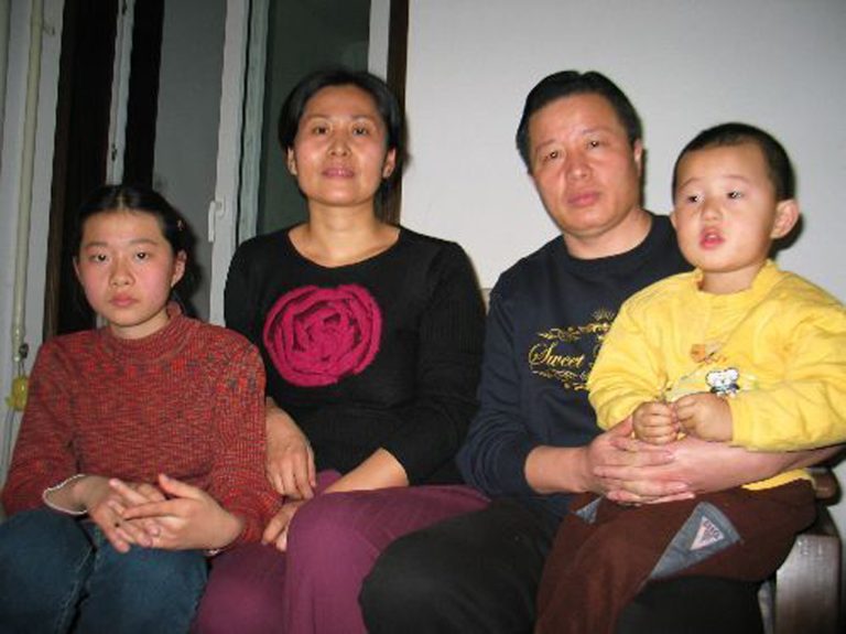 FILE - In this file photo taken Jan. 6, 2006 and released by Hu Jia, Gao Zhisheng, a human rights lawyer, second from right, poses for photos with his son Gao Tianyu, right, and his wife Geng He, second from left, and daughter Geng Ge, left, at their home in Beijing, China. An activist said Gao, one of China's best-known rights lawyers and fiery government critic ,has been released from prison but appears to be under close supervision by the authorities. Hu Jia said Gao was freed Thursday, Aug. 7, 2014,  from a prison in a remote far-western county and is with his brother. (AP Photo/Hu Jia, File)
