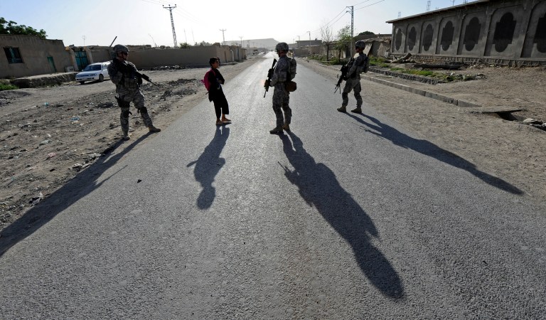 Members of Provincial Reconstruction Team Zabul talk with a young Afghan boy about school while on a mission to inspect a construction project in Qalat, Afghanistan. (U.S. Air Force Staff Sgt. Brian Ferguson)
