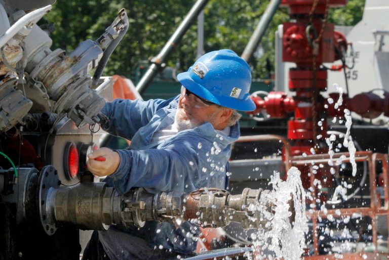 AÂ contractor closes a valve on his tanker truck after watering down the dirt roads to keep the dust down at the Range Resources hydraulic fracturing operation in Claysville, Pa. The company is one of the many using the fracking process to extract natural gas from the deep wells drilled into the Marcellus Shale in the region. (AP Photo)