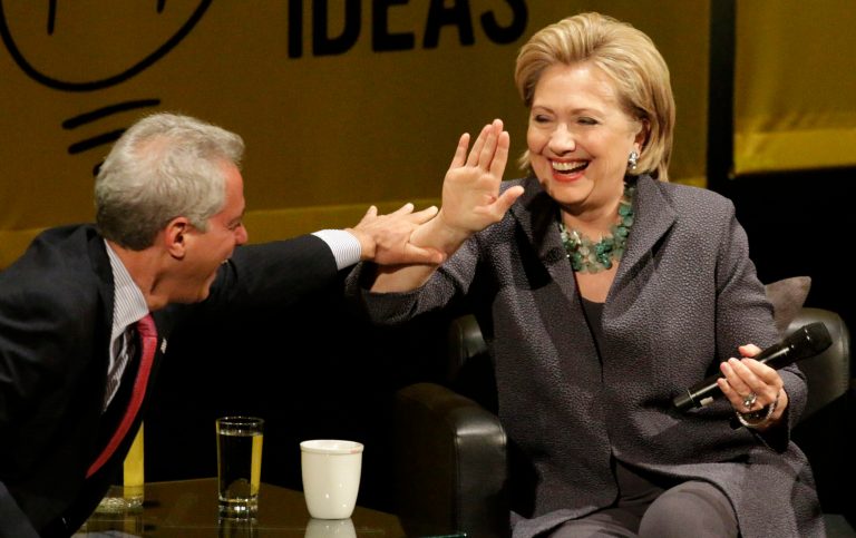 Former Secretary of State Hillary Rodham Clinton laughs with Chicago Mayor Rahm Emanuel after he missed her hand during a high-five attempt, Wednesday, June 11, 2014, in Chicago, during an event promote her new book. (AP Photo/Stacy Thacker)