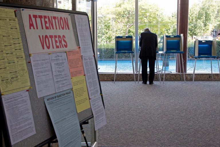 FILE - In this Sept. 9, 2010 file phoro, a  lone voter takes part in early voting in Milwaukee. The Supreme Court deals with churning election rules in several states less than a month from November's voting, blocking voter ID laws in Wisconsin while siding with Republicans for stricter rules in  North Carolina and Ohio. In Texas, a federal court strikes down a voter ID law, but the state may still appeal that ruling.  (AP Photo/Morry Gash)
