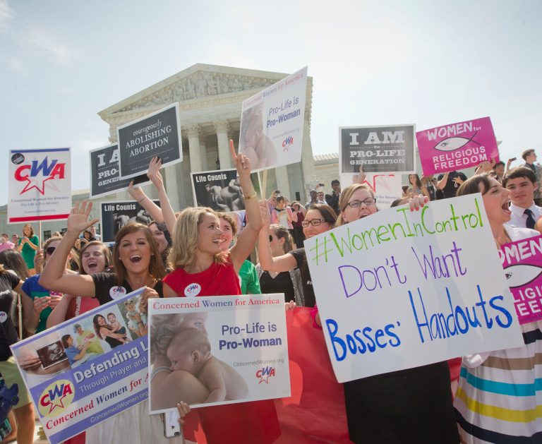 Demonstrators react to hearing the Supreme Court's decision on the Hobby Lobby case outside the Supreme Court in Washington, Monday, June 30. (AP Photo/Pablo Martinez Monsivais)