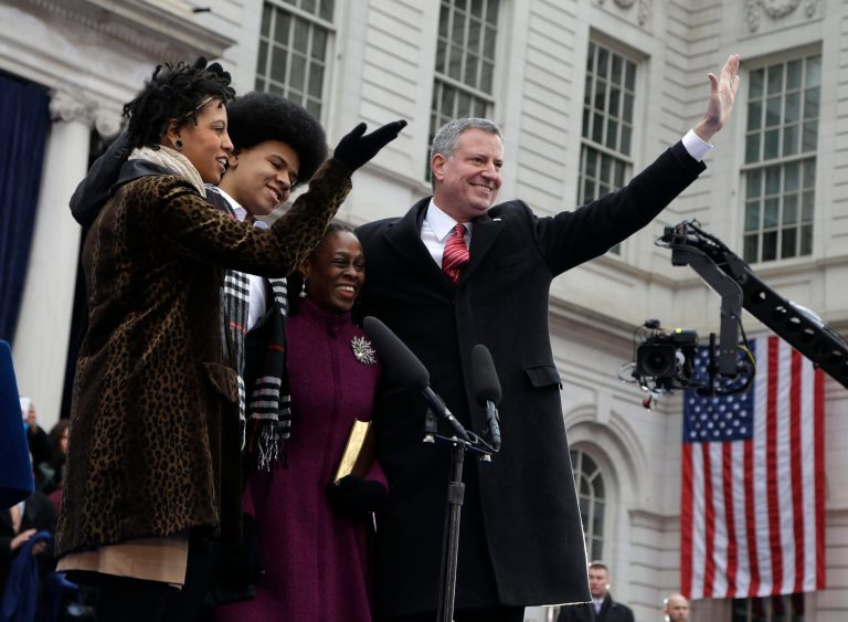 New York City Mayor Bill de Blasio, right, his wife Chirlane McCray, second from right, and his children Chiara, left, and Dante de Blasio wave to the crowd after Bill de Blasio took the oath of office during the public inauguration ceremony at City Hall in New York on Wednesday. (AP Photo/Seth Wenig)