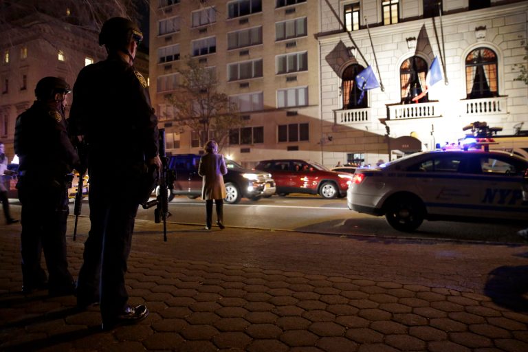Heavily armed New York City police officers with Operation Hercules stand guard across the street from the French consulate on New York's Fifth Ave., Friday, Nov. 13, 2015. Police in New York say they've deployed extra units to crowded areas of the city 