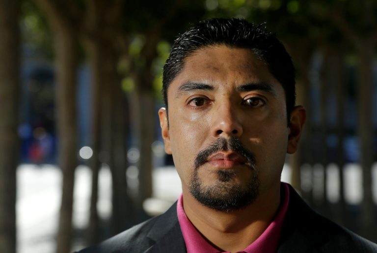 In this Tuesday, Sept. 3, 2013, photo, Sergio Garcia poses for photographs in San Francisco. Garcia arrived in Northern California illegally 20 years ago and and has been there since, and was admitted to the California bar after a state Supreme Court decision Jan. 2. (AP Photo/Jeff Chiu)