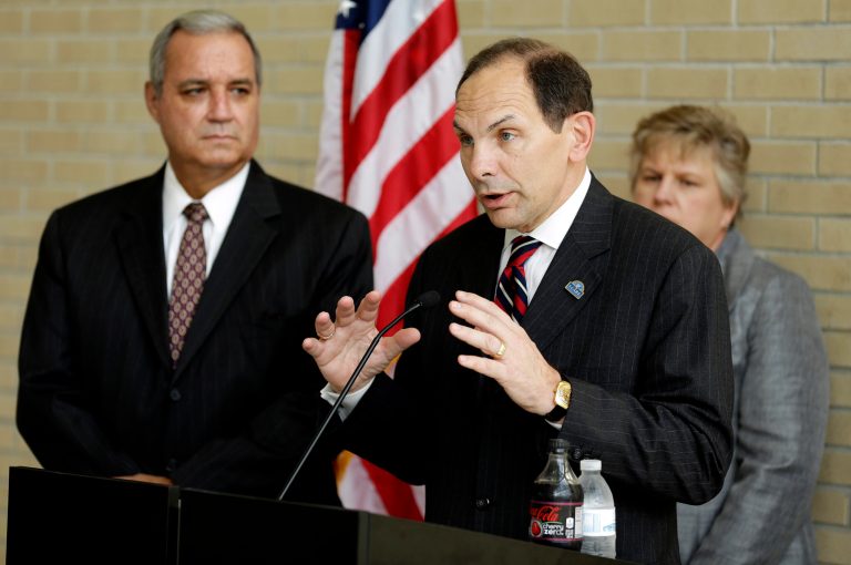 U.S. Secretary of Veterans Affairs Robert A. McDonald, center, speaks while surrounded by U.S. Rep. Jeff Miller, left, R-Fla., Chairman of the House Committee on Veterans Affairs and Kathleen Fogarty, Director of the James A. Haley Medical Center during a news conference after a visit to the James A. Haley Medical Center, Wednesday, Oct. 1, 2014, in Tampa, Fla. (AP Photo/Chris O'Meara)