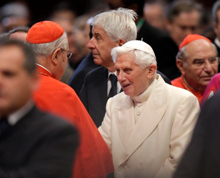 Pope Emeritus Benedict XVI is greeted by Cardinal Angelo Sodano, left, as he arrives for a consistory inside the St. Peter's Basilica at the Vatican, Saturday, Feb.22, 2014. Benedict XVI has joined Pope Francis in a ceremony creating the cardinals who will elect their successor in an unprecedented blending of papacies past, present and future. (AP Photo/Alessandra Tarantino)