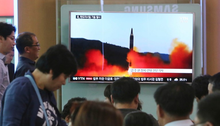 People watch a TV news program showing a file image of a missile launch by North Korea, at the Seoul Railway Station in Seoul, South Korea. (AP Photo/Ahn Young-joon)