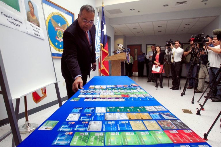 McAllen Police Chief Victor Rodriguez displays dozens of fraudulent credit cards that were confiscated by McAllen police after arresting a man and a woman on fraud charges tied to the December Target credit card breach, Monday Jan. 20, 2014 at the McAllen Police Department in McAllen, Texas. Rodriguez said Mary Carmen Garcia, 27, and Daniel Guardiola Dominguez, 28, both of Monterrey, Mexico, were arrested Sunday, Jan. 19, 2014 after arriving at the border with 96 fraudulent credit cards. (AP Photo/The Monitor, Gabe Hernandez)  MAGS OUT; TV OUT