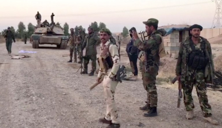 Iraqi state media say Iraqi soldiers have entered disputed territories occupied by the nation's Kurds. The move comes three years after Kurdish militias seized the areas outside their autonomous region to defend against an advance by the Islamic State extremist group. (APTN via AP)