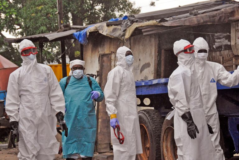 Liberian health workers outside a home of a man that they believed died from the Ebola virus in Monrovia, Liberia, Friday, Aug. 29, 2014.  The Ebola outbreak in West Africa eventually could exceed 20,000 cases, more than six times as many as are now known, the World Health Organization said Thursday. A new plan released by the U.N. health agency to stop Ebola also assumes that the actual number of cases in many hard-hit areas may be two to four times higher than currently reported.(AP Photo/Abbas Dulleh)