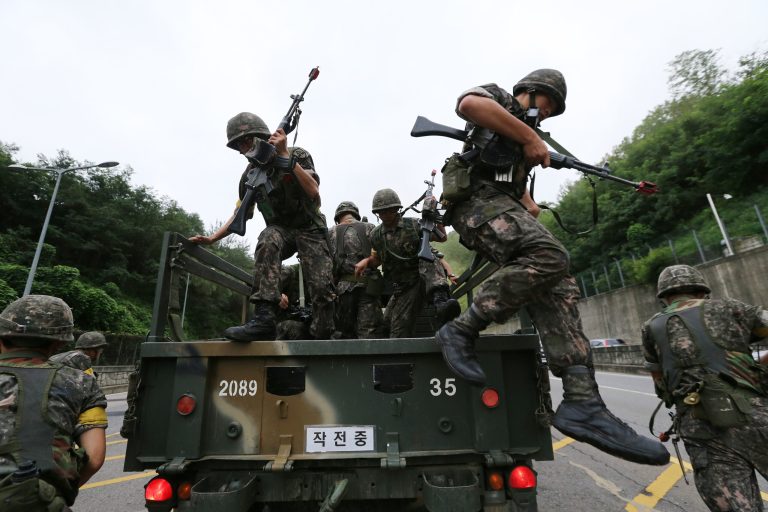 South Korean army soldiers get off a truck during an anti-terror exercise as part of Ulchi Freedom Guardian in Seoul, South Korea, Monday, Aug. 18, 2014. (AP Photo/Ahn Young-joon)
