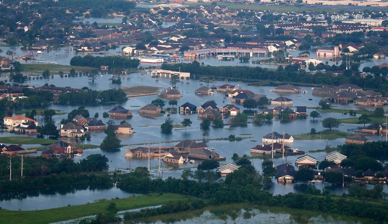 Floodwaters from Tropical Storm Harvey surround homes and businesses in Texas. A White House aide said Thursday roughly 100,000 homes have been affected. (AP Photo/Gerald Herbert)