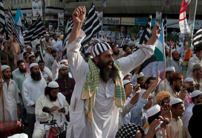 Supporters of Pakistani religious party Jamiat Ulema-e-Islam attend pro-government rally in Karachi, Pakistan, Friday, Aug. 22, 2014. Thousands of supporters of Pakistan's cricketer-turned-politician Imran Khan and cleric Tahir-ul-Qadri   are besieging parliament in the capital to pressure Prime Minister Nawaz Sharif to resign over alleged election fraud. (AP Photo/Shakil Adil)