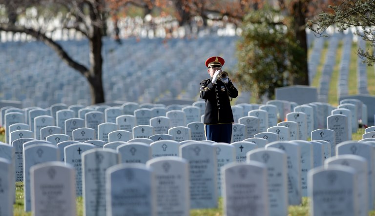 In this 2016 photo, a bugler plays 