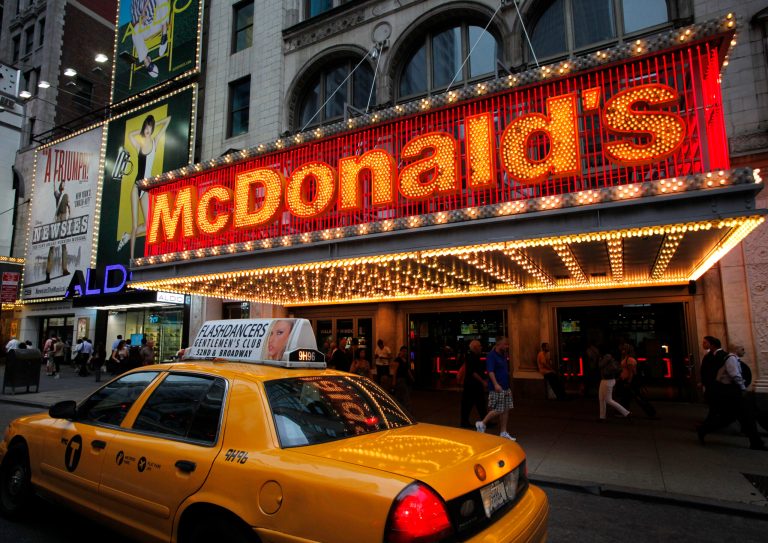 FILE - In this July 11, 2013 photo, a taxi cab passes a McDonald's restaurant in New York's Times Square. McDonald's Corp. reports quarterly financial results before the market opens on Tuesday, July 22, 2014. (AP Photo/Mark Lennihan, File)