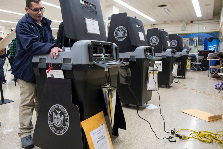 New York City Board of Elections technician Hector Bosquez repairs a ballot-scanning machine at a polling station in the Brooklyn borough of New York on Nov. 8. (AP Photo/Alexander F. Yuan)