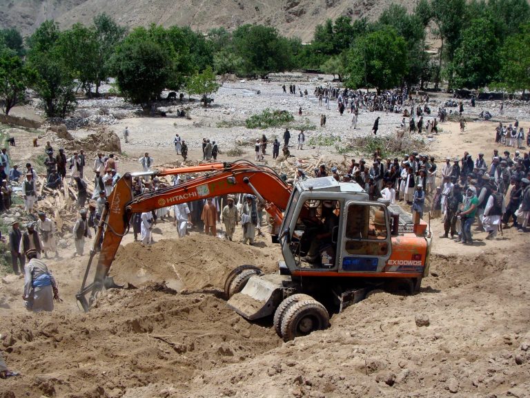   FILE - In this Tuesday, June 12, 2012 file photo, people search for victims of Monday's earthquake in Baghlan, north of Kabul, Afghanistan. Afghan officials say they are halting efforts to dig out scores of bodies from the site of a devastating landslide that followed earthquakes in northern Afghanistan earlier this week. (AP Photo/Jawed Bashara, File)  