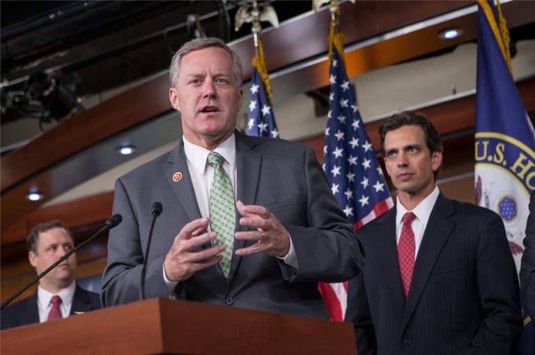 Rep. Mark Meadows, R-N.C, center, Rep. Tom Graves, R-Ga., right, and other conservative Republicans discuss their goal of obstructing the Affordable Care Act as part of a strategy to pass legislation to fund the government, on Capitol Hill in Washington, Thursday, Sept. 19.