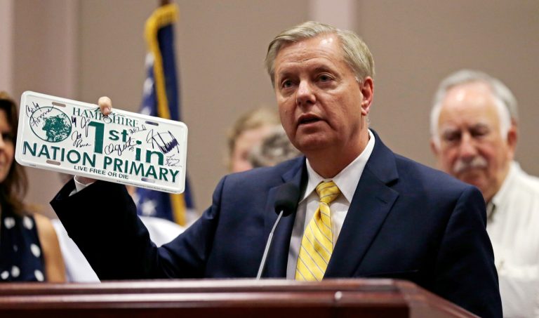 Republican presidential candidate, Sen. Lindsey Graham, R-S.C., holds up a license plate signed by other presidential candidates during a campaign event at city hall in Manchester, N.H., Wednesday, July 15, 2015. (AP Photo/Charles Krupa)
