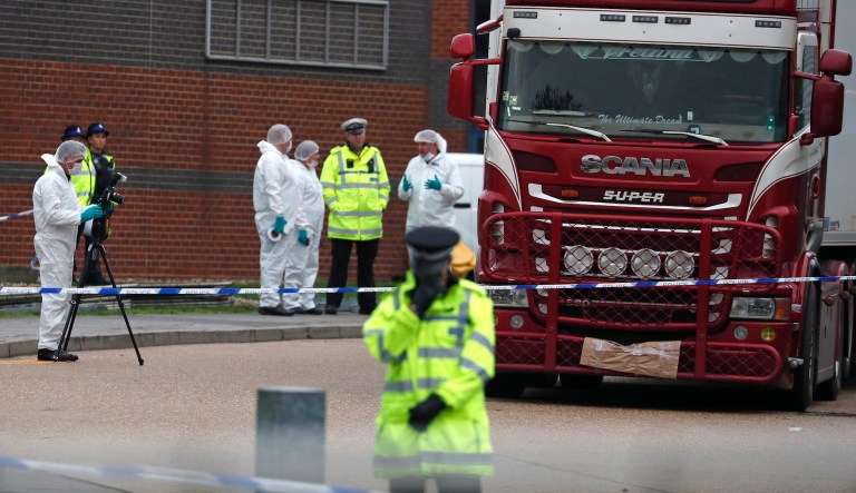 Police forensic officers attend the scene after a truck was found to contain a large number of dead bodies, in Thurrock, South England, Wednesday Oct. 23, 2019. Police in southeastern England said that 39 people were found dead Wednesday inside a truck container believed to have come from Bulgaria.