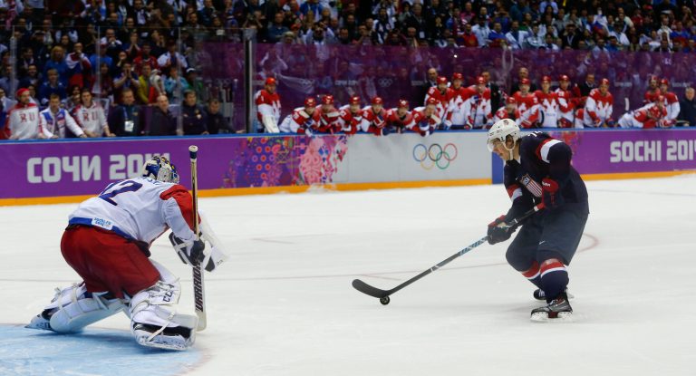 U.S.A. forward T.J. Oshie prepares to take a shot against Russia goaltender Sergei Bobrovski in an overtime shootout during a men's ice hockey game at the 2014 Winter Olympics, Saturday, Feb. 15, 2014, in Sochi, Russia. (AP Photo/Julio Cortez)