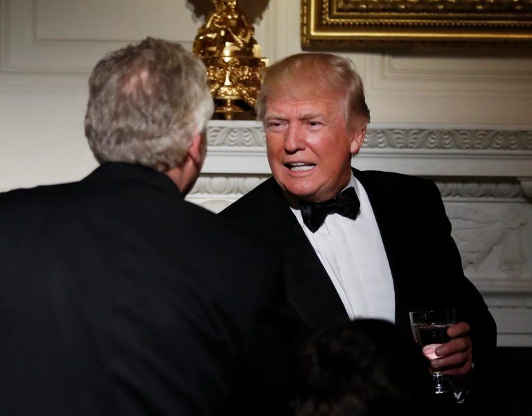 President Donald Trump shakes hands with National Governors Association Chair Democrat Virginia Gov. Terry McAuliffe, during a dinner reception for the annual National Governors Association winter meeting Sunday, Feb. 26, 2017, at the State Dining Room of the White House, in Washington. (AP Photo/Manuel Balce Ceneta)