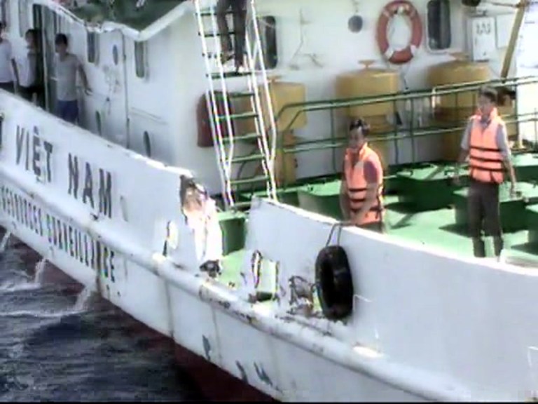 In this video image released by Vietnam Coast Guard, Vietnamese surveillance ship crew members stand near the side of the ship, allegedly damaged after being rammed by a Chinese ship, in the South China Sea, off Vietnam's coast, Wednesday, May 7, 2014. Chinese ships have been ramming into and firing water cannons at Vietnamese vessels trying to stop Beijing from putting an oil rig in the South China Sea, according to officials and video footage Wednesday, in a dangerous escalation of tensions over waters considered a global flashpoint. (AP Photo/Vietnam Coast Guard)
