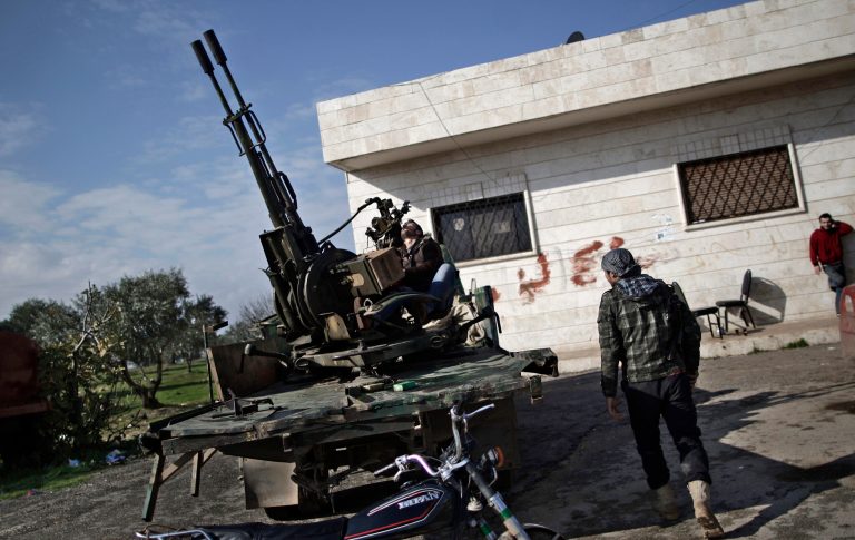   In this Friday, Dec. 14, 2012 photo, a Syrian rebel checks an anti-aircraft weapon, in Maaret Misreen, near Idlib, Syria. The new Syrian rebel chief, a defected army general who spent months in exile, says he has begun operating inside Syria to unite autonomous anti-regime militias for what he hopes will be the final push against President Bashar Assad. (AP Photo/Muhammed Muheisen)  