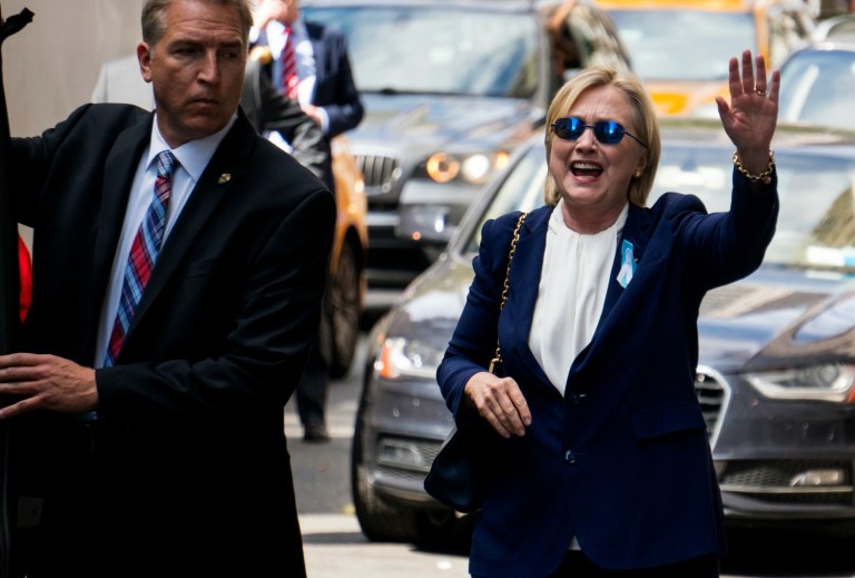 Democratic presidential candidate Hillary Clinton waves as she walks from her daughter's apartment building Sunday, Sept. 11, 2016, in New York. Clinton unexpectedly left Sunday's 9/11 anniversary ceremony in New York after feeling 