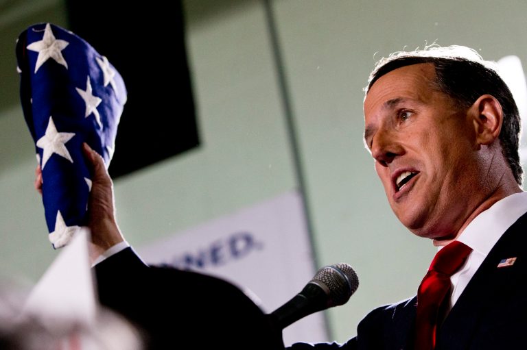 Former Pennsylvania Sen. Rick Santorum holds up a folded U.S. flag during his announcement that he is entering the Republican presidential race, Wednesday, May 27, 2015, in Cabot, Pa. (AP Photo/Jacquelyn Martin)