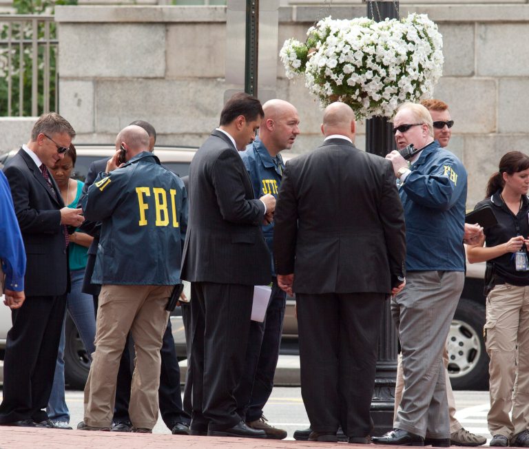 Washington Police and FBI agents gather outside the Family Research Council in Washington, Wednesday, Aug. 15, 2012, after security guard at the lobbying group was been shot in the arm. (AP Photo/J. Scott Applewhite)
