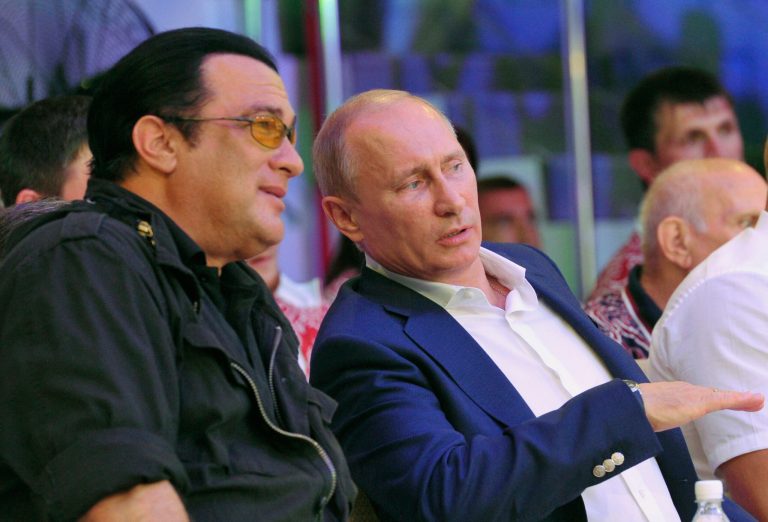 FILE - This is a Saturday, Aug. 11, 2012, file photo  Russian President Vladimir Putin, and U.S. actor Steven Seagal, left, as they watch the first Russian national championship of mixed martial arts in the Black Sea resort of Sochi, southern Russia. The Russian news RIA Novosti says American actor Steven Seagal has performed at a concert in the breakaway region of Crimea on a stage decorated with the flag of pro-Russian separatists fighting in eastern Ukraine. Seagal, who knows Russian President Vladimir Putin, performed Saturday Aug. 9, 2014 in the Black Sea port city of Sevastopol at a concert organized by a motorcycle gang of Russian nationalists known as the Night Wolves. Russia annexed the Ukrainian region in March.(AP Photo/RIA-Novosti,  Alexei Nikolsky, Presidential Press Service, File)