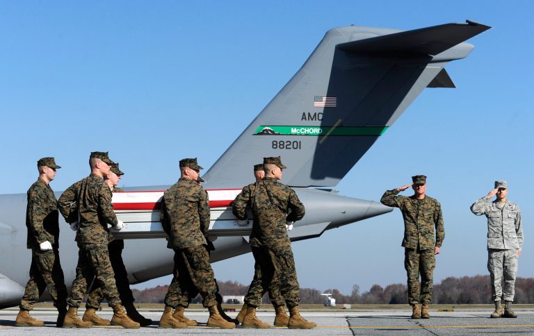 A U.S. Marine carry team moves a transfer case containing the remains of Marine Lance Cpl. Dale W. Means, Wednesday, Nov. 21, 2012, at Dover Air Force Base, Del. (AP Photo/Steve Ruark)