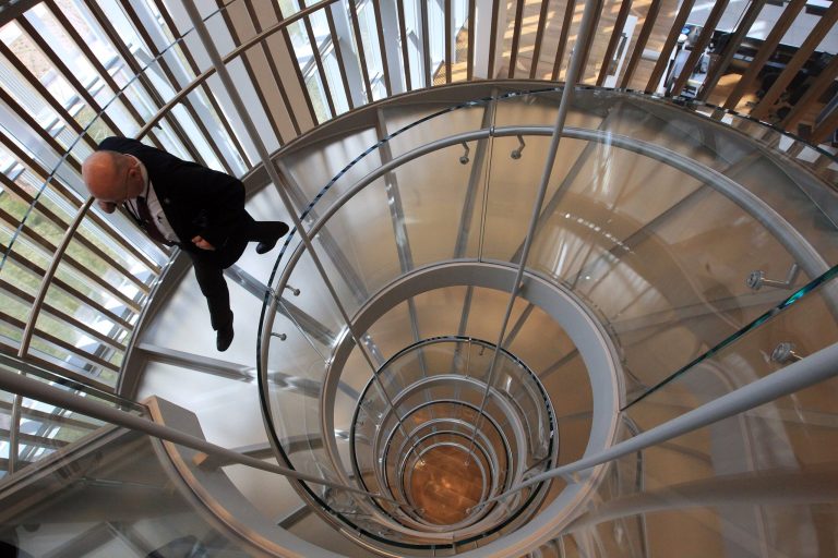A person descends a spiral staircase during a media tour of the new Salt Lake City Federal Courthouse, Wednesday, April 9, 2014. Federal court cases playing out in Utah will soon have a glossier, more modern setting. Officials on Wednesday are celebrating the opening of a new federal courthouse in downtown Salt Lake City, next-door to the existing building. They say it's a much-needed upgrade, with more space and better security. The $185 million building is designed to harness natural sunlight and use energy more efficiently. (AP Photo/Rick Bowmer)