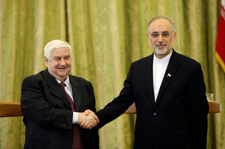 Syrian Foreign Minister Walid al-Moallem, left, and his Iranian counterpart Ali Akbar Salehi, shake hands, at the conclusion of their press conference, in Tehran, Iran, Saturday, March 2, 2013. The Syrian and Iranian foreign ministers on Saturday accused the United States of double standards over the Obama administration's decision to provide aid to rebels fighting to topple President Bashar Assad, saying this will only prolong the conflict. (AP Photo/Vahid Salemi)