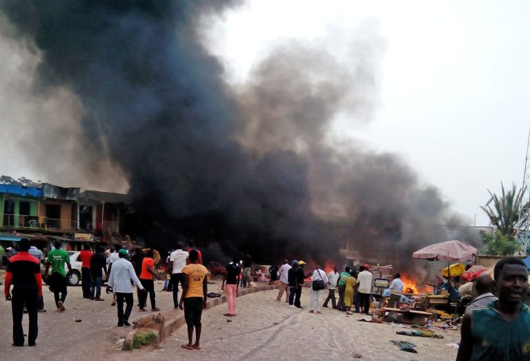 Smoke rises after a bomb blast at a bus terminal in Jos, Nigeria, Tuesday, May 20, 2014. Two explosions ripped through a bustling bus terminal and market frequented by thousands of people in Nigeria's central city of Jos on Tuesday afternoon, and police said there are an unknown number of casualties. The blasts could be heard miles away and clouds of black smoke rose above the city as firefighters and rescue workers struggled to reach the area as thousands of people fled. (AP Photo/Stefanos Foundation)