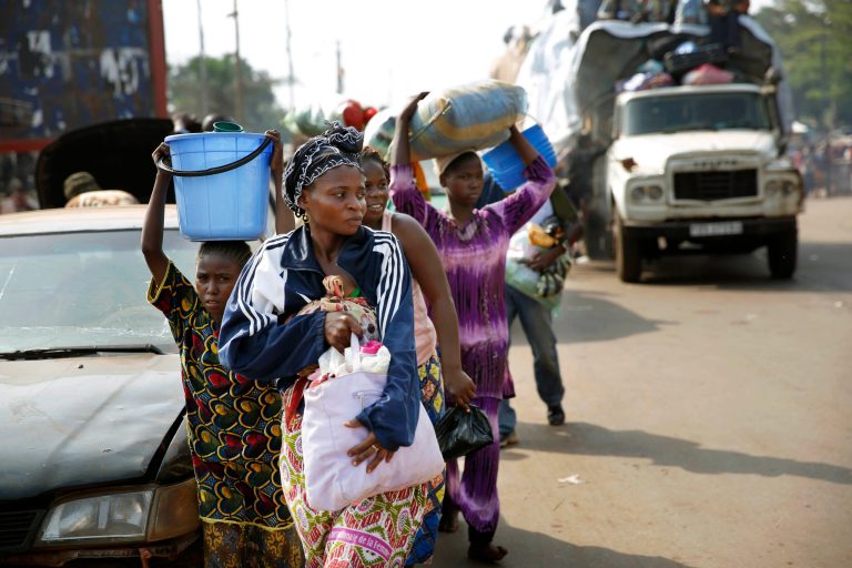 At PK12 thousands of Muslim residents from Bangui and Mbaiki flee the Central African Republic Bangui in a mass exodus using cars, pickups, trucks, lorries and motorcycles, escorted by Chadian troops on Friday Feb. 7, 2014. Tit-for-tat violence killed more than 1,000 people in Bangui alone in a matter of days in December. An untold number have died in the weeks that followed, with most of the attacks in Bangui targeting Muslims. (AP Photo/Jerome Delay)