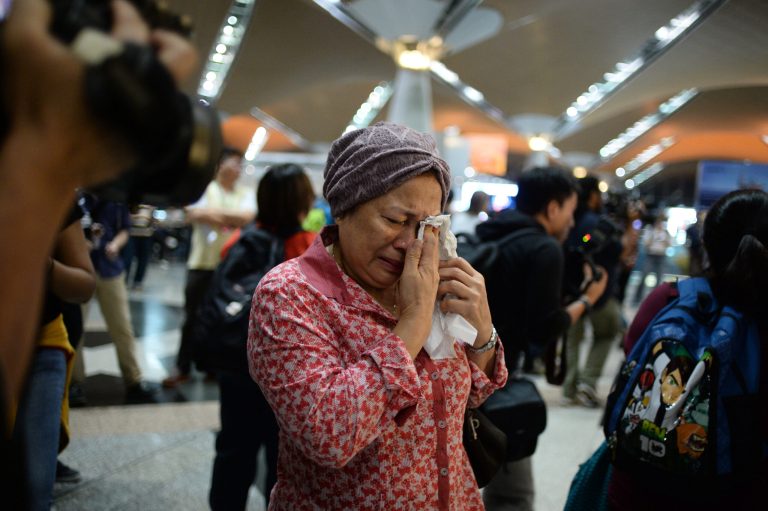 A woman reacts to news regarding a Malaysia Airlines plane that crashed in eastern Ukraine at Kuala Lumpur International Airport in Sepang, Malaysia, Friday, July 18, 2014.  Malaysia Airlines said it lost contact with Flight 17 over Ukrainian airspace Thursday. It was flying from Amsterdam to Kuala Lumpur, Malaysia. (AP Photo/Joshua Paul)