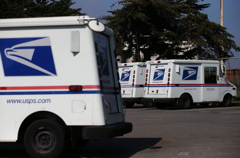 Postal Service mail vehicles sit in a parking lot at a mail distribution center on February 18, 2015 in San Francisco, California. (Photo by Justin Sullivan/Getty Images)