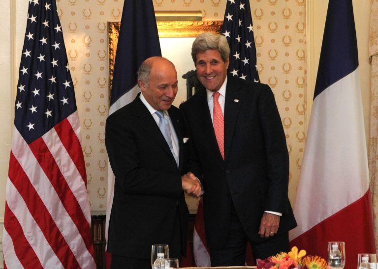 French Foreign Minister Laurent Fabius, left, and U.S. Secretary of State John Kerry shake hands before a meeting at the Waldorf Astoria in New York Sunday Sept. 21, 2014.  (AP Photo/Tina Fineberg)
