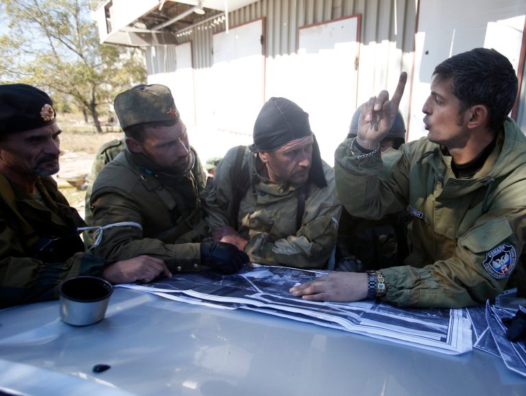 Pro-Russian rebels prepare for action near to the airport in the town of Donetsk, eastern Ukraine, Friday, Oct. 3, 2014. Pro-Russian rebels are pressing to seize a key airport in eastern Ukraine despite fierce resistance by government forces. (AP Photo/Darko Vojinovic)
