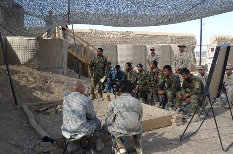 Afghan soldiers and police get briefed during a training mission at Camp Leatherneck in Helmand Province, in Afghanistan, in June 2012. (AP Photo/Heidi Vogt)