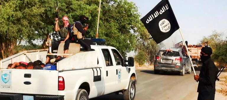 This Image posted on a militant website on Saturday, June 14, 2014, which has been verified and is consistent with other AP reporting, appears to show militants from the al Qaeda-inspired Islamic State of Iraq and the Levant (ISIL) with truckloads of captured Iraqi soldiers after taking over a base in Tikrit, Iraq. (AP Photo via militant website)